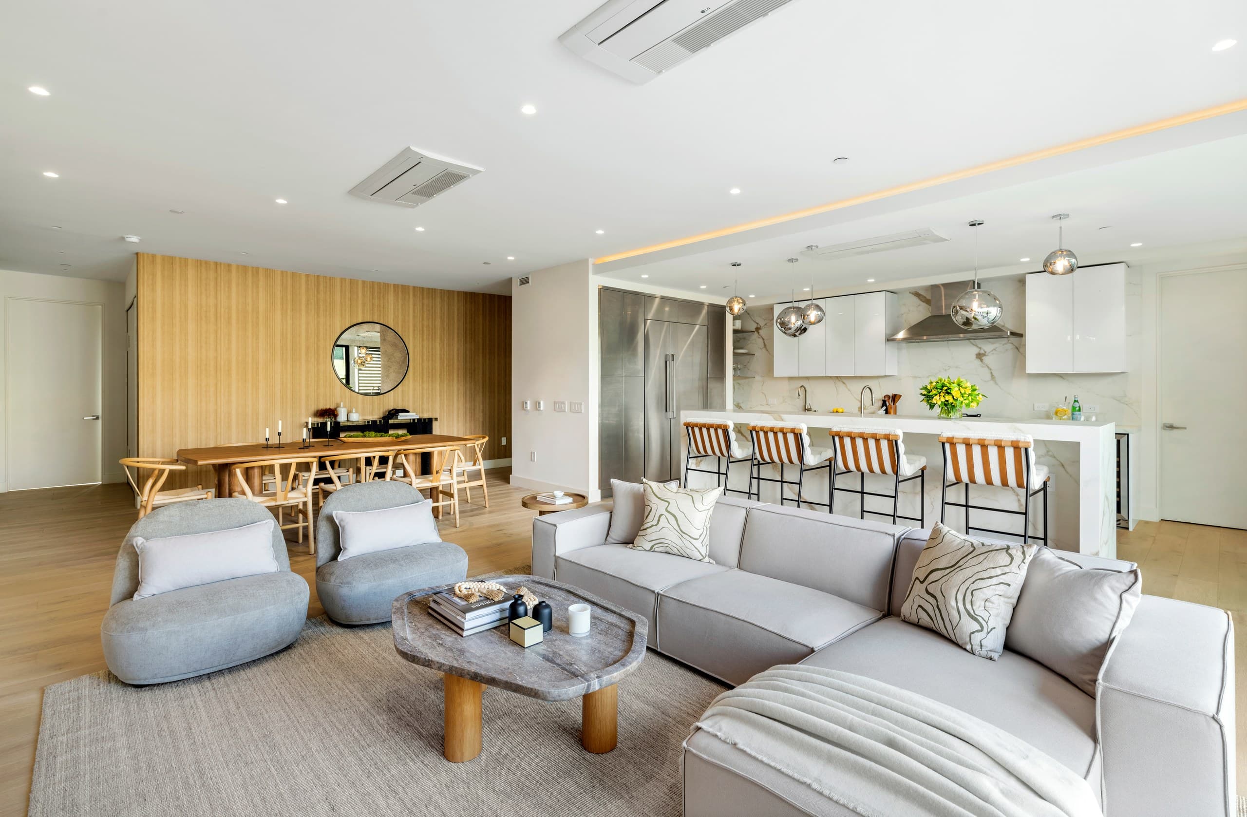 Sunlit great room with floor-to-ceiling glass opening to a terrace at Lumiere at Malcolm