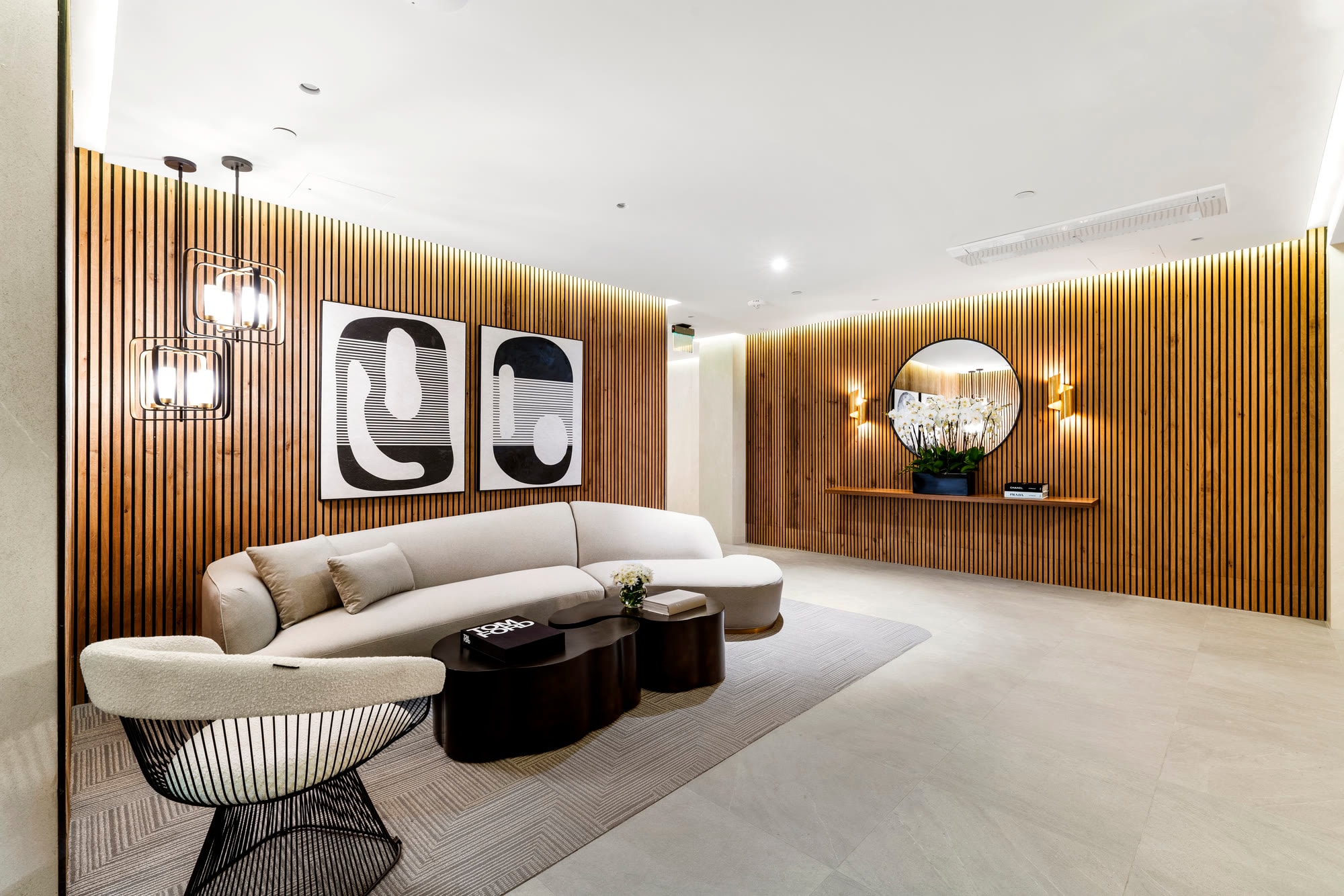 Furnished residents' lounge with oak-slat walls at Lumiere at Malcolm