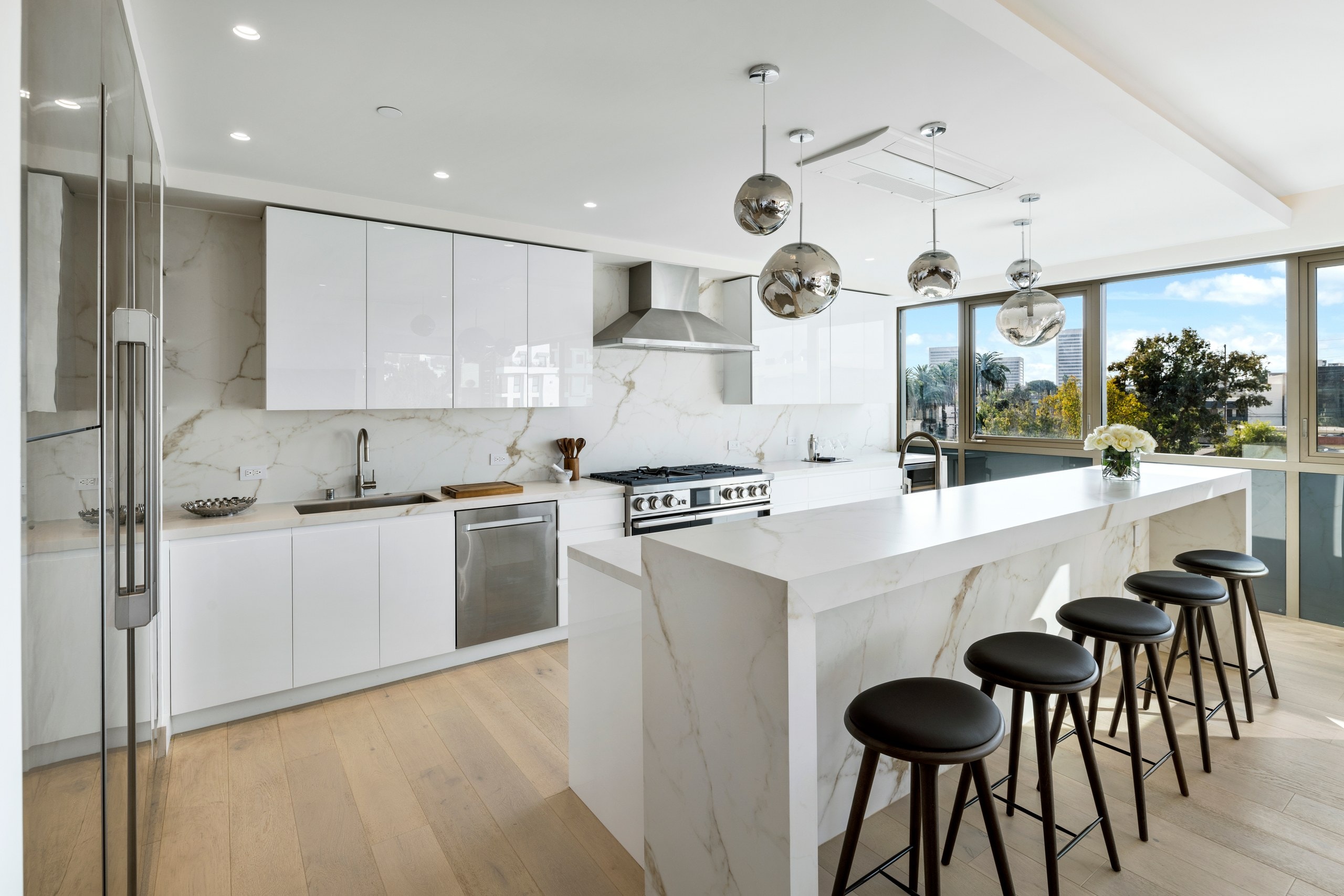 Calacatta Oro kitchen with a waterfall island at Lumiere at Malcolm