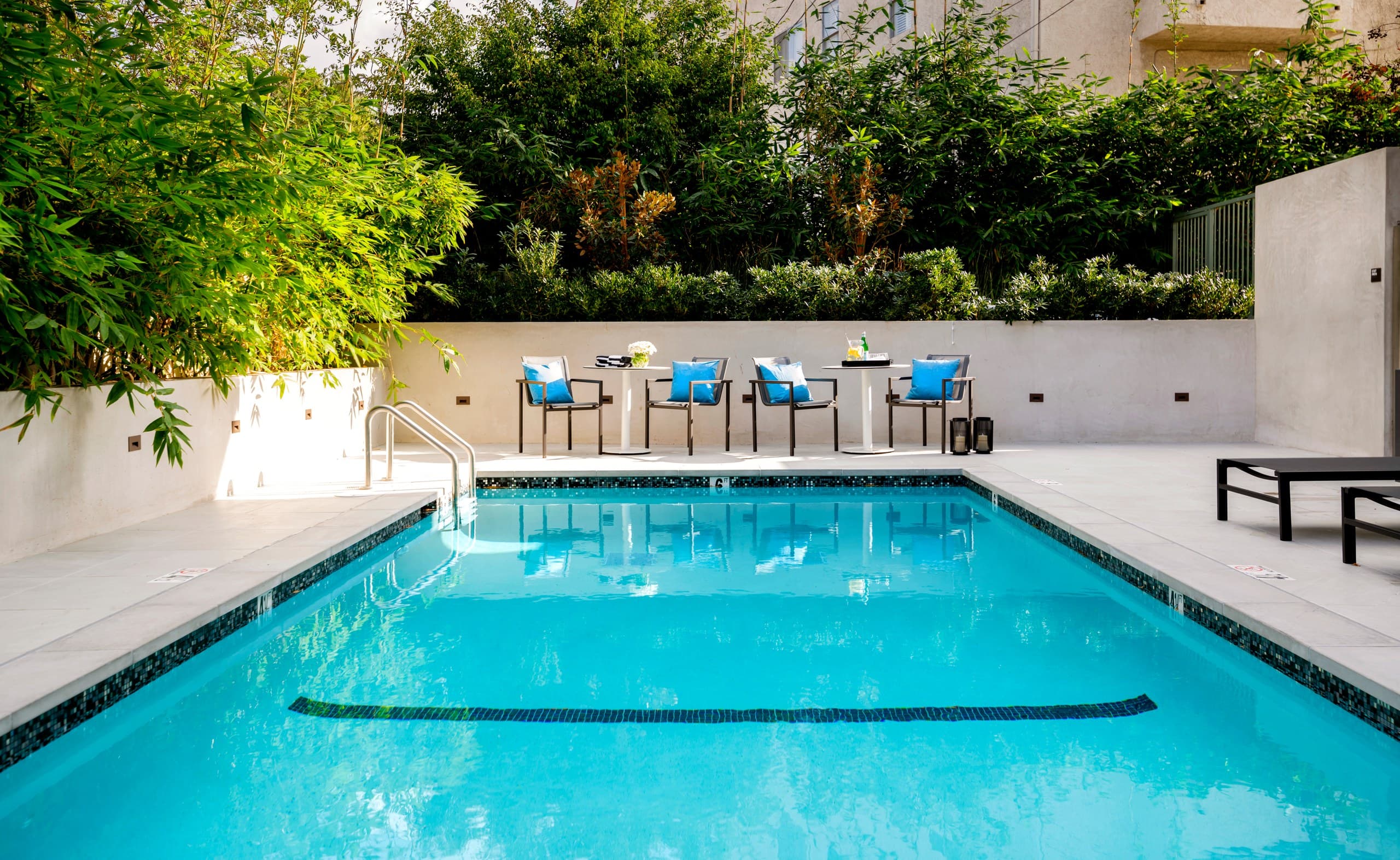 Resort-style salt water pool with lounge seating at Lumiere at Malcolm