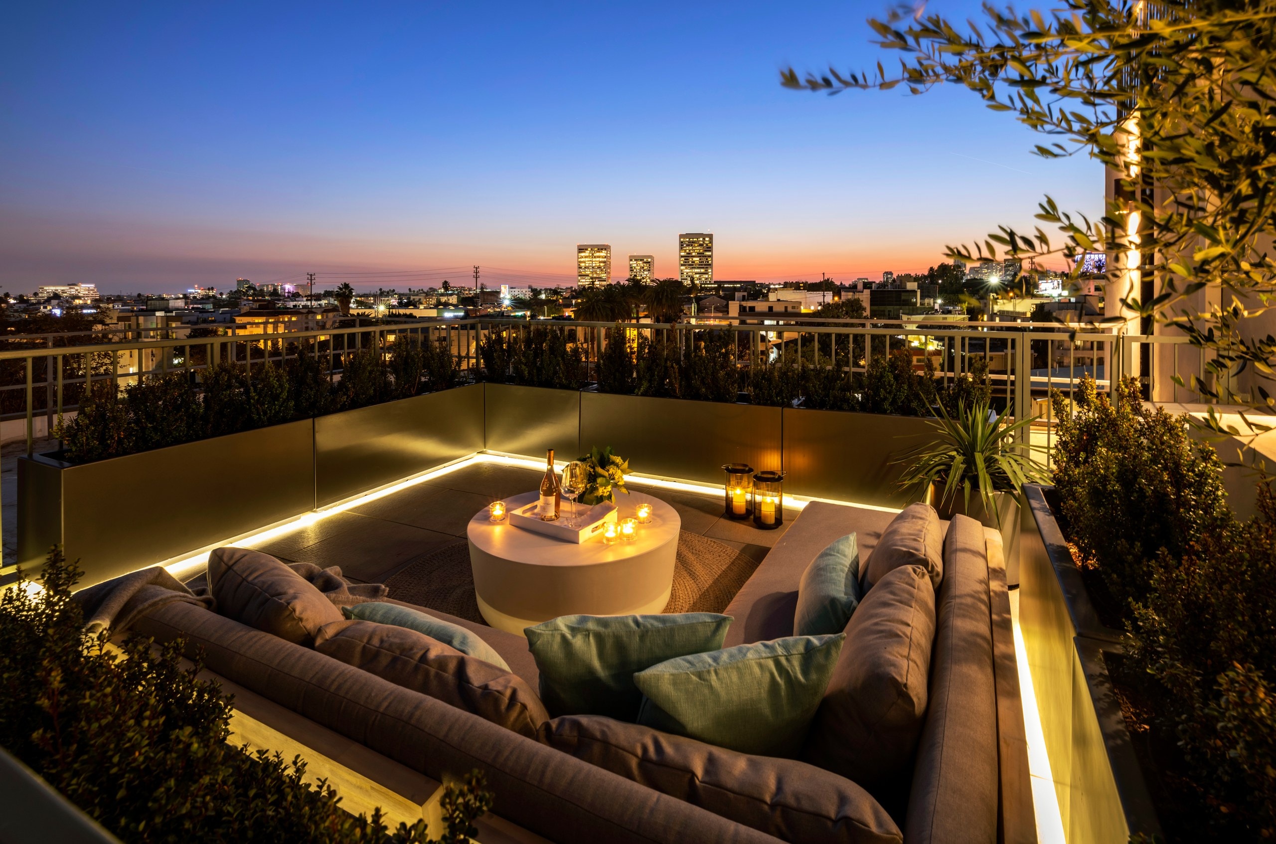 Rooftop lounge at dusk with city lights at Lumiere at Malcolm