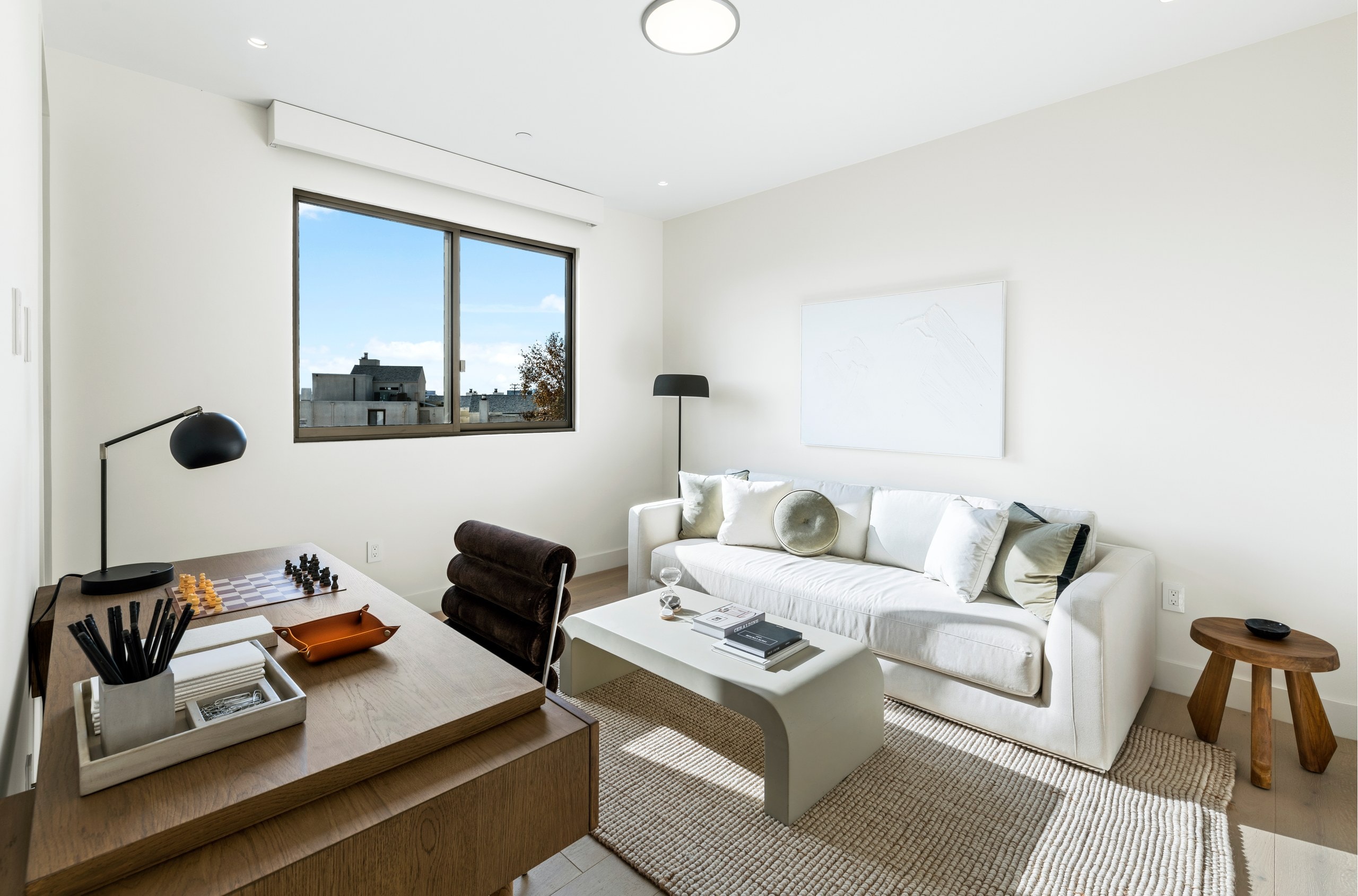 Calm sitting room with a sofa and a work nook at Lumiere at Malcolm