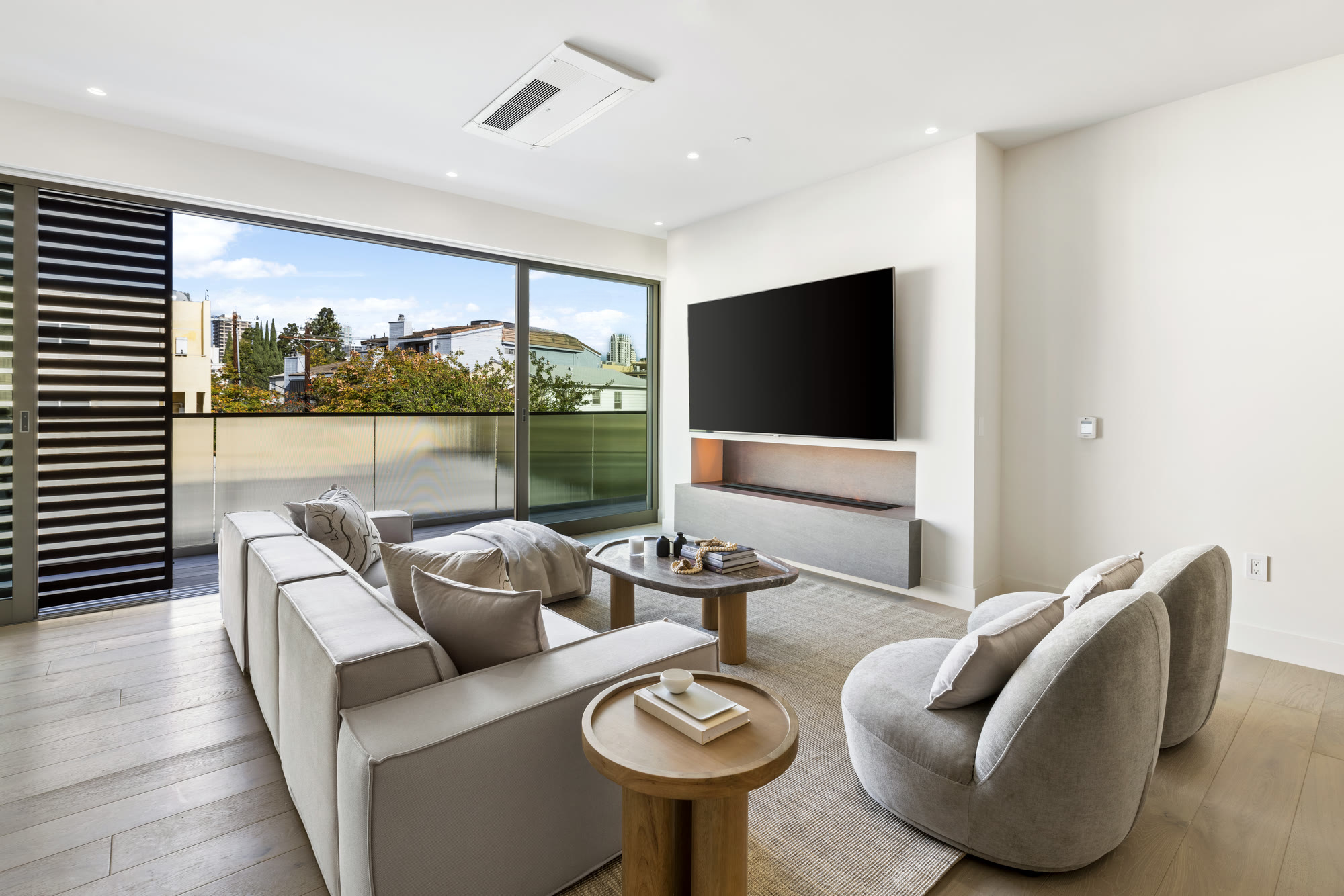 Open-plan living room with floor-to-ceiling glass and terrace at Lumiere at Malcolm