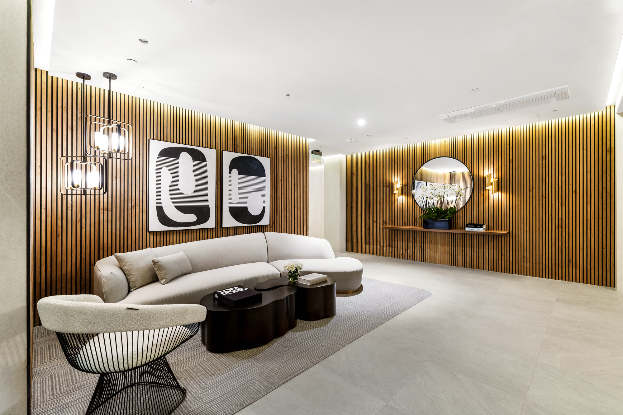 Furnished residents' lobby with oak slat walls at Lumiere at Malcolm